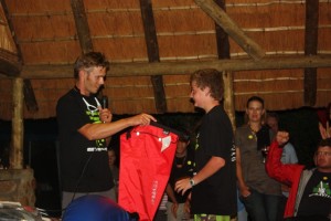 Brent accepting a PeakUk dry bag on behalf of Ryan for his 2nd place in the Beginner Kayaking cat.